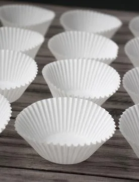 Cupcake Liners Empty Cupcake Forms Arranged on a Wooden Table. Stock Photos