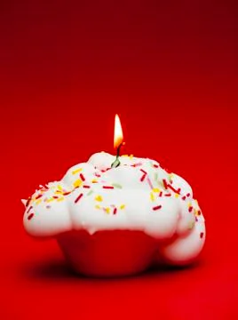 Cupcake with a lit candle Stock Photos