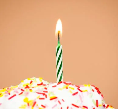 Cupcake with a lit candle Stock Photos