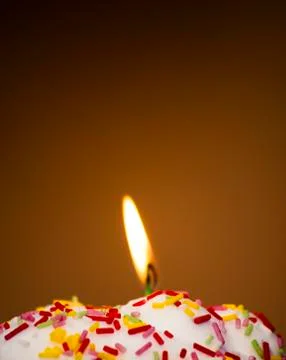Cupcake with a lit candle Stock Photos
