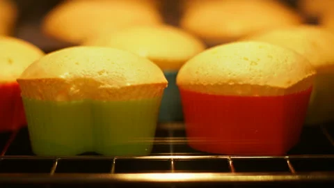 Cupcake muffin baking in oven closeup. Magdeleines baked in time lapse video. Stock Footage 87875791