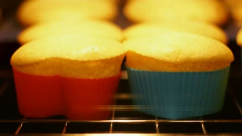 Cupcake muffin baking in oven closeup. Magdeleines baked in time lapse video. Stock Footage 87880375