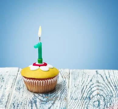 Cupcake with number one on a blue background Stock Photos