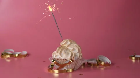 Cupcake or cake with sparkler on pink background, Stock Footage 166515579