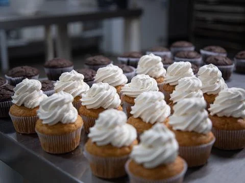 Cupcake production inside the bakery Stock Photos