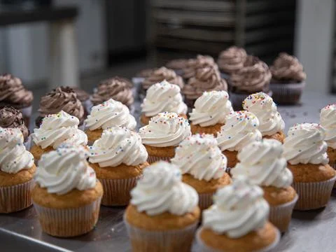 Cupcake production inside the bakery Stock Photos