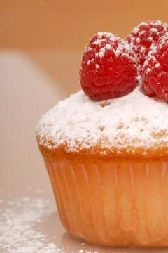 Cupcake with raspberries Stock Photos