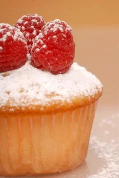 Cupcake with raspberries Stock Photos