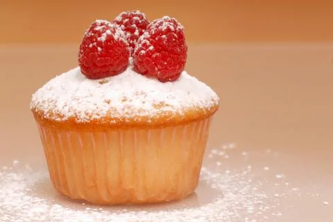 Cupcake with raspberries Stock Photos