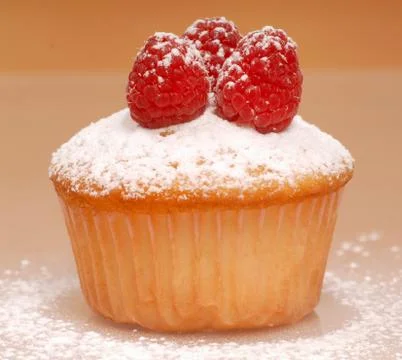 Cupcake with raspberries Stock Photos