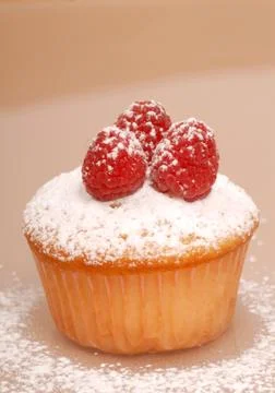 Cupcake with raspberry Stock Photos