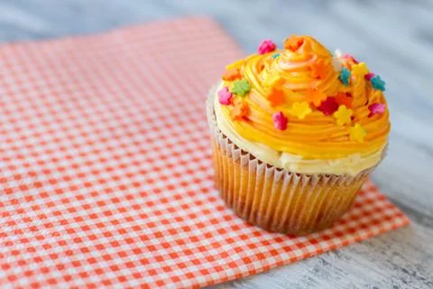 Cupcake on red napkin. Stock Photos