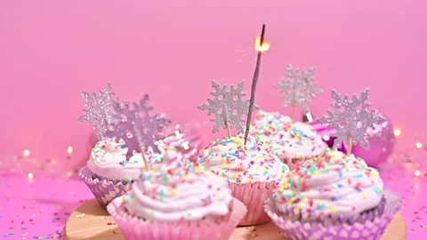 Cupcake Sparkle: Igniting Christmas Magic with Glittering Fire Delights Stock Footage 255337112