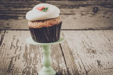 Cupcake on stand with rustic background Stock Photos