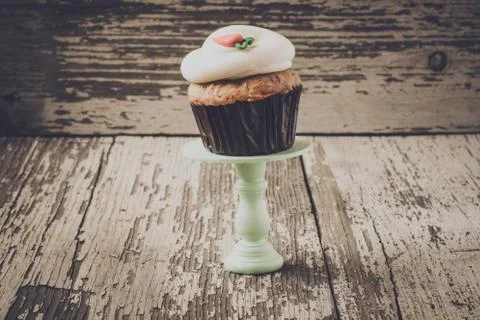 Cupcake on stand with rustic background Stock Photos