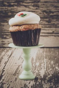 Cupcake on stand with rustic background Stock Photos