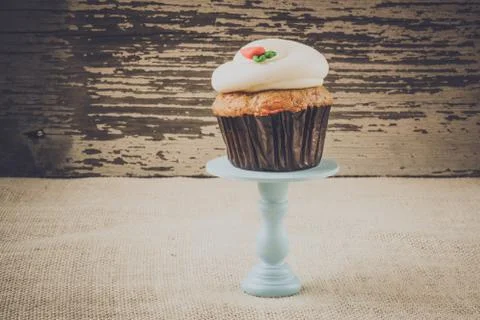 Cupcake on stand with rustic background Stock Photos