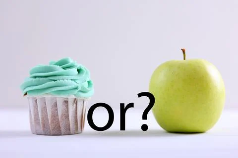 Cupcake versus Apple A Debate Between Sweet Indulgence or a Healthy Snack Choice Stock Photos