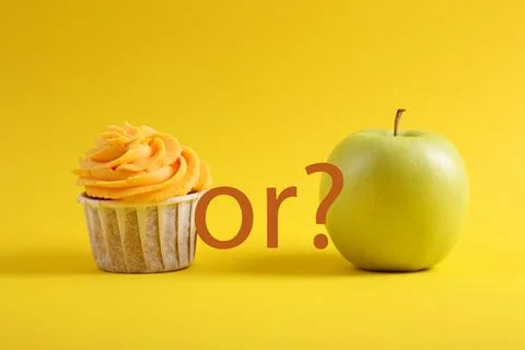 Cupcake versus Apple A Debate Between Sweet Indulgence or a Healthy Snack Choice Stock Photos