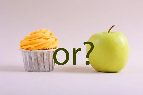 Cupcake versus Apple A Debate Between Sweet Indulgence or a Healthy Snack Choice Stock Photos