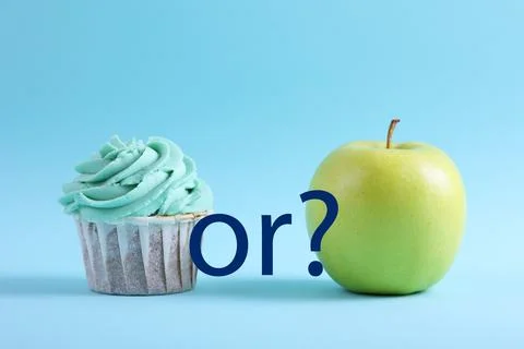 Cupcake versus Apple A Debate Between Sweet Indulgence or a Healthy Snack Choice Stock Photos