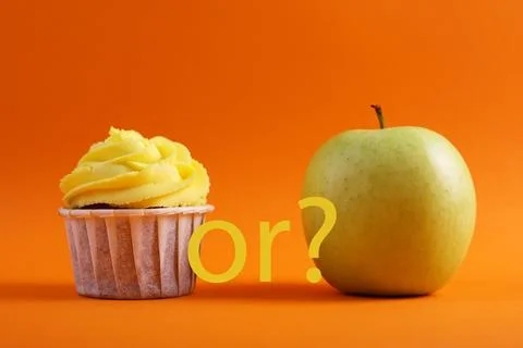 Cupcake versus Apple A Debate Between Sweet Indulgence or a Healthy Snack Choice Stock Photos