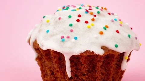 Cupcake with white sweet icing and assorted small urps Stock Footage 170238873