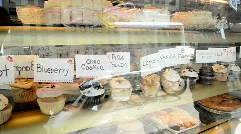 Cupcakes in bakery window Stock Footage 22407677