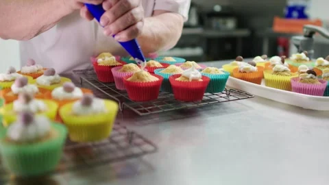 Cupcakes being iced by chef Stock Footage 247456298
