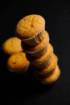 Cupcakes on a black background. Baking Stock Photos