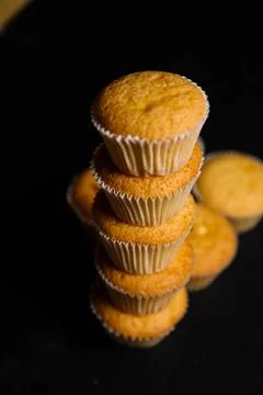 Cupcakes on a black background. Baking Stock Photos