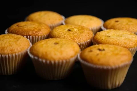 Cupcakes on a black background. Baking Stock Photos