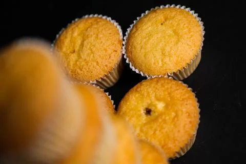 Cupcakes on a black background. Baking Stock Photos