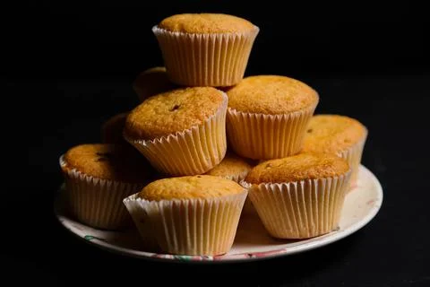 Cupcakes on a black background. Baking Stock Photos