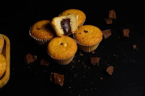 Cupcakes on a black background. Baking Stock Photos