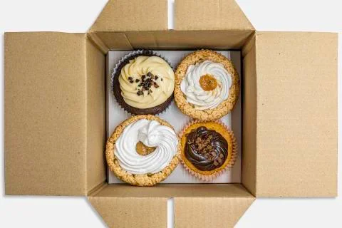 Cupcakes of different flavors inside the packaging for deliveries Stock Photos