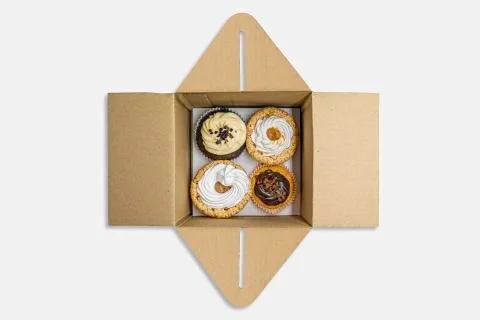 Cupcakes of different flavors inside the packaging for deliveries Stock Photos