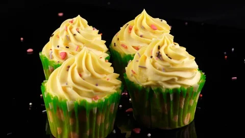 Cupcakes, Falling various small colored sugar sprinkles, black background Stock Footage 91029279