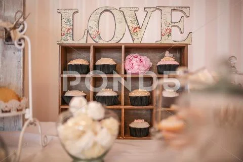 Cupcakes in a small closet with the word love above Stock Photos