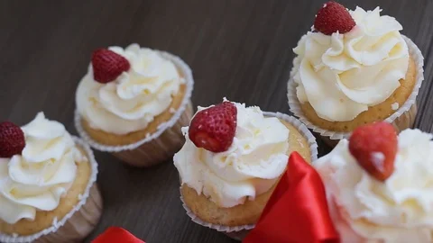 Cupcakes on the table. The camera makes a fly over the table and slowly goes int Stock Footage 98854602