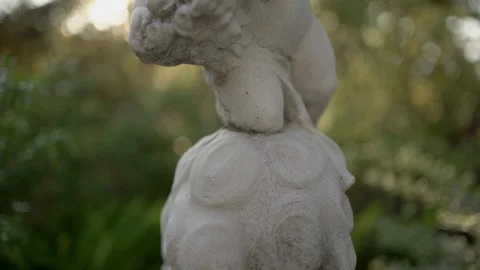 Cupids statue in the garden at evening. Stock Footage 126485589