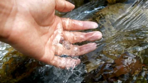 Cupped female hands gathering fresh clean source water, Ecology. wide angle Stock Footage 270406773