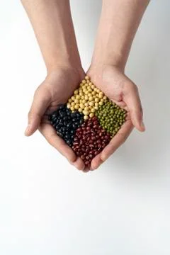Cupped hands holding multicolored beans and legumes 写真素材