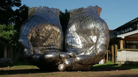 Cupped hands by Sculptor Rick Kirby outside Woodbridge Quay Church Stock Footage 76622718
