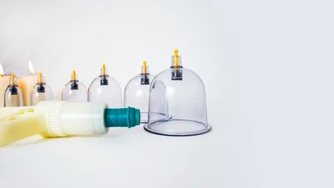 Cupping pump and a set of cups for vacuum massage and candles Stock-Fotos