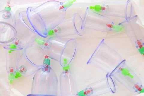 Cupping therapy plastic cups in a white container, ready for use in a massage Stock Photos