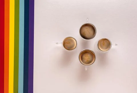 Cups with coffee on white with rainbow background Stock Photos