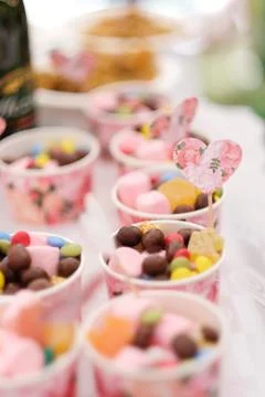 Cups filled with sweets on the table at a children's party Stock Photos