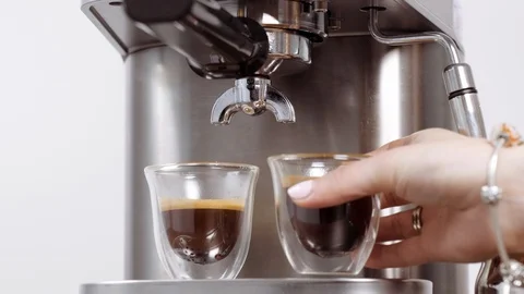 Cups with fresh coffee from professional machine. Hand taking away espresso. Stock Footage 112678698