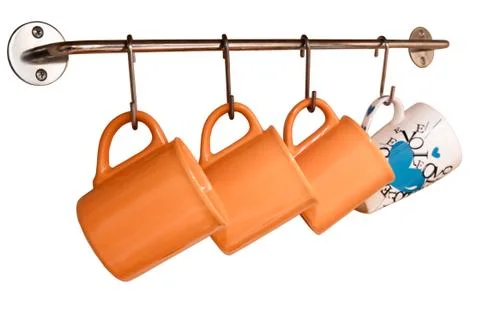 Cups hanging on the wall Stock Photos